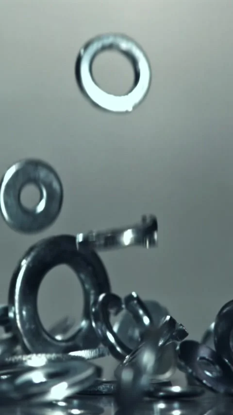 Metal washers fall on the table. Filmed on a high-speed camera at 1000 fps Stock Footage 335367704