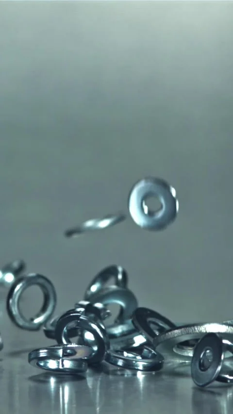 Metal washers fall on the table. Filmed on a high-speed camera at 1000 fps Stock Footage 335373170