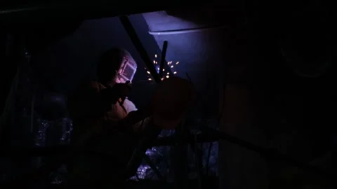Metal welding in darkness shooting from below Stock Footage 229699271