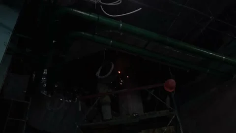 Metal welding in darkness under the ceiling shooting from below Stock Footage 229699117