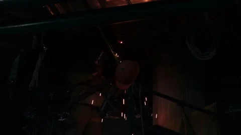 Metal welding in darkness under the ceiling shooting from below Stock Footage 229699143