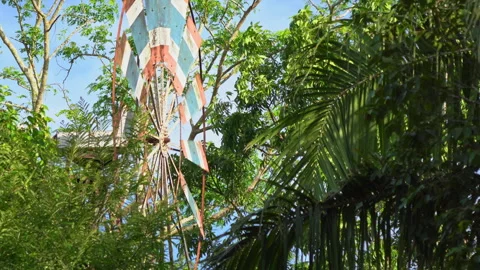 Metal windmill painted in Thai flag colors spinning in wind Stock Footage 347449593