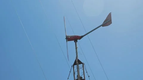 Metal windmill rotates under blue sky Video stock 130791841