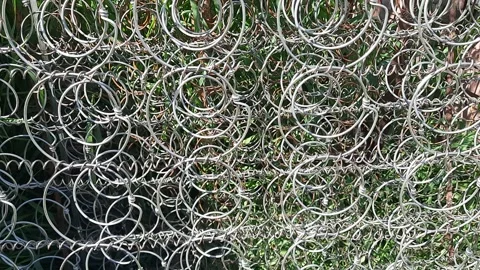 Metal wire coils arranged in pattern with green background Stock Footage 310308607