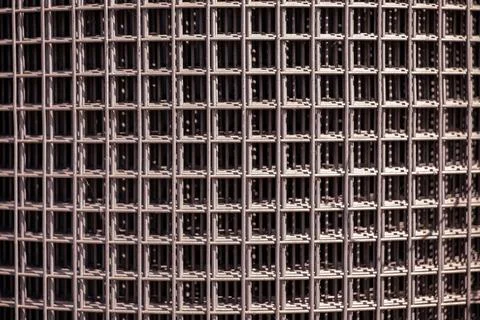 Metal wire mesh texture creating grid pattern for industrial background Stock Photos