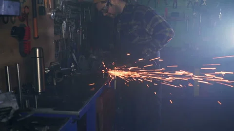 Metal worker in protective eyeglasses, using grinder at the workplace. Stock Footage 124169059