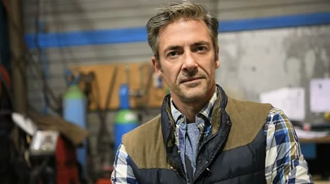 Metal worker standing in workshop looking at camera Video stock 59784918