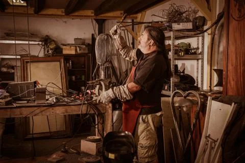 Metal worker standing in workshop 스톡 사진