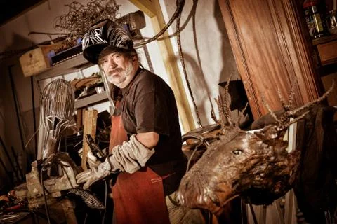 Metal worker standing in workshop 스톡 사진