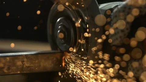 Metal worker using angle grinder to cut steel square tube in professional w.. Stock Footage 337597311