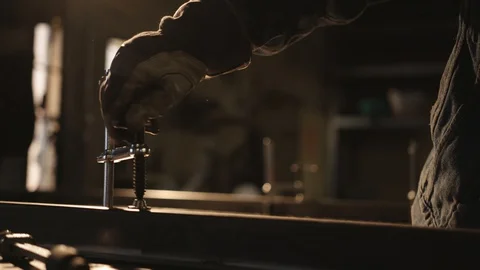 Metal worker using a clamp Stock Footage 128773545
