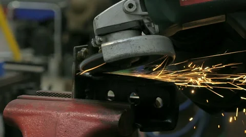 A metal worker using grinder on a metal car part . Video stock 59065341