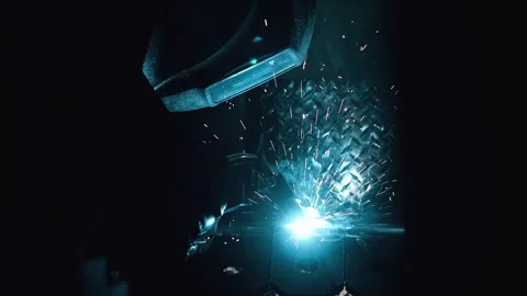 Metal worker welding in dark work shop - high contrast slow motion Stock Footage 168464629