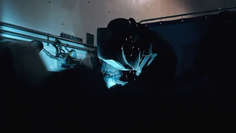Metal worker welding in dark work shop - high contrast slow motion Stock Footage 168464745