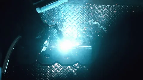 Metal worker welding in dark work shop - high contrast slow motion Stock Footage 168464822