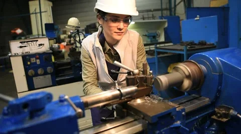 Metal worker woman using machine in workshop Stock Footage 59773884