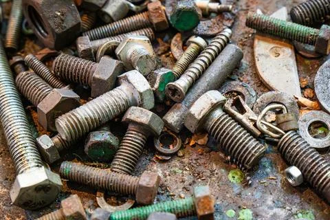 Metal working workshop with assorted screws, bolts, and nuts on a workbench Stock Photos