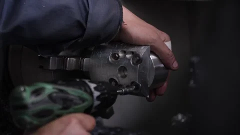 Metal workshop worker is using cordless screwdriver to tighten screws. Stock Footage 313815408