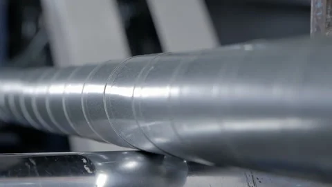 A metal-wrapped cable moving along a conveyor belt. Cable Production Line Stock Footage 149428664