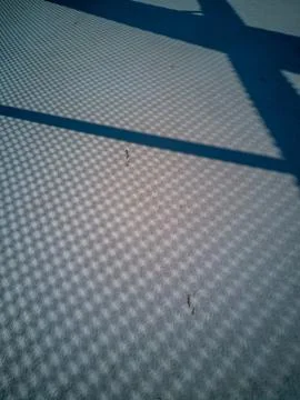 Metalic net shadow pattern on concrete pavement 2 Stock Photos