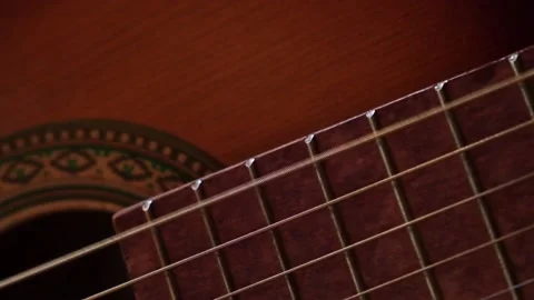 Metalic strings vibrating on classical acoustic guitar when musician playing 스톡 동영상 224377530