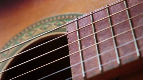 Metalic strings vibrating on classical acoustic guitar when musician playing 스톡 동영상 226227878