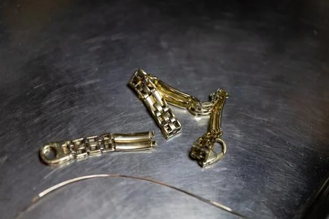 Metallic accessories on a dark surface during a crafting session in the evening Stock Photos