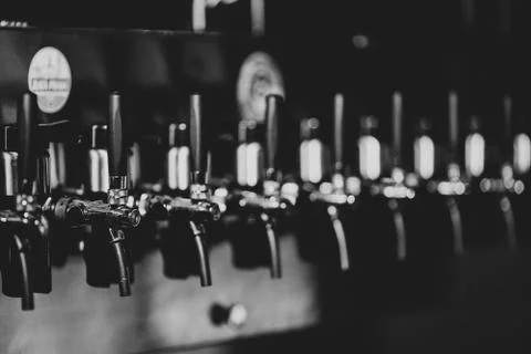 Metallic beer taps in a empty bar Stock Photos