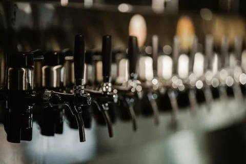 Metallic beer taps in a empty bar Stock Photos