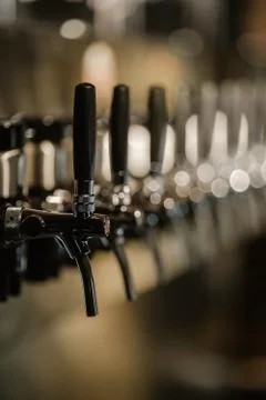 Metallic beer taps in a empty bar Stock Photos