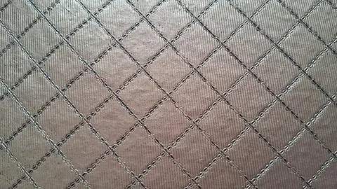 Metallic brown surface with a repeating diamond quilted stitched pattern Foto stock