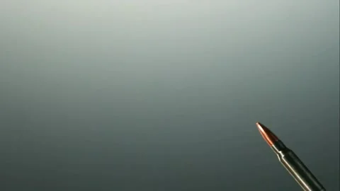 Metallic bullets and shell casings falling down 動画素材 327121185