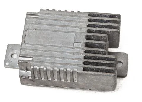 Metallic car engine control unit with plastic elements on a white isolated ba Stock Photos