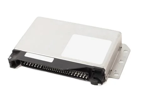 Metallic car engine control unit with plastic elements on a white isolated ba 스톡 사진