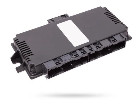 Metallic car engine control unit with plastic elements on a white isolated .. Stock Photos