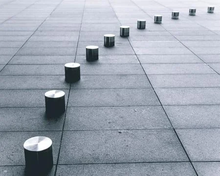 Metallic columns on the sidewalk Stock Photos