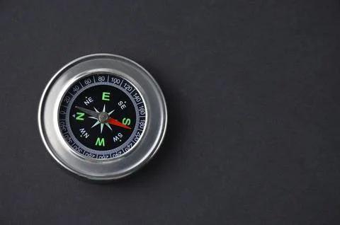 Metallic compass on a black background. Stock Photos