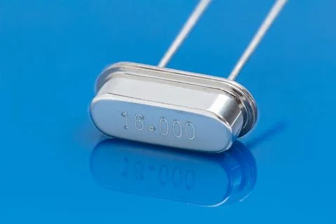 Metallic component rests on reflective blue surface Stock Photos
