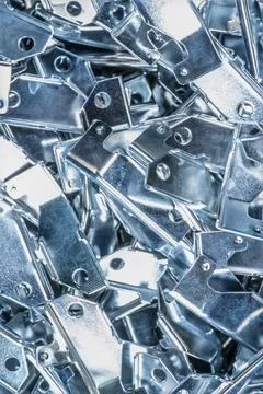 Metallic components grouped together, featuring various holes and shapes Stock Photos
