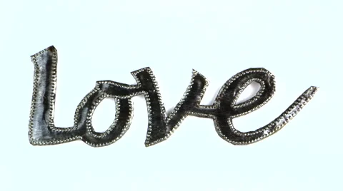 Metallic cursive word  "Love" slide in from the right Stock Footage 49771794