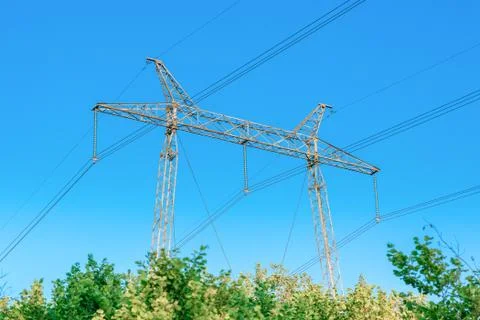 Metallic electrical tower transmitting high voltage. Energy industry. Stock Photos