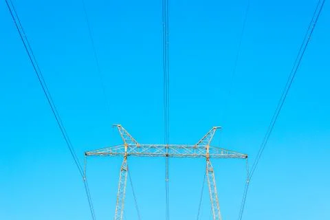 Metallic electrical tower transmitting high voltage. Energy industry Stock Photos
