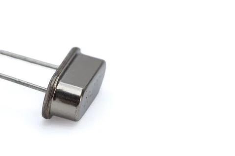 Metallic electronic component against pure white background Stock Photos