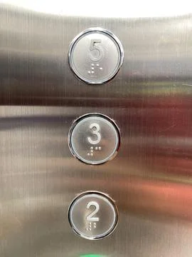 Metallic elevator buttons show numbers 2, 3, and 5. Stock Photos
