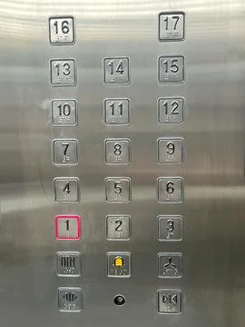 Metallic elevator control panel displays numbered buttons Stock Photos