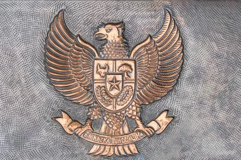 Metallic emblem showcases stylized eagle atop shield with crest, possibly a.. Stock Photos