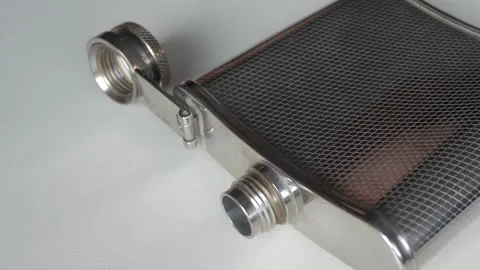 Metallic flask on white surface, zoom out Stock Footage 315125143