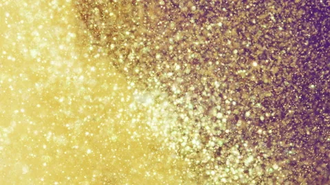Metallic gold particles flow through liquid. VJ Stock Footage 130264818