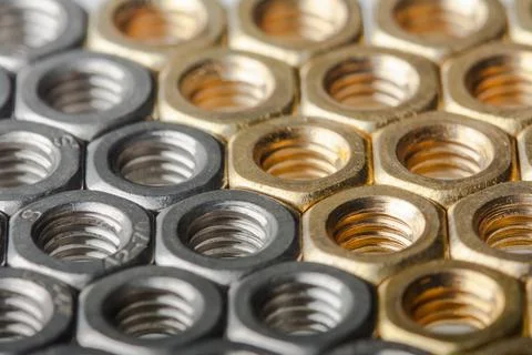 Metallic hex nuts layed out in a hexagonal pattern Stock Photos