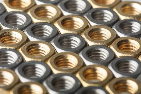 Metallic hex nuts layed out in a hexagonal pattern Stock Photos